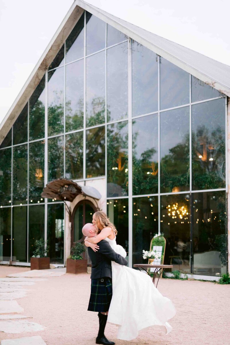 groom lifts bride off floor