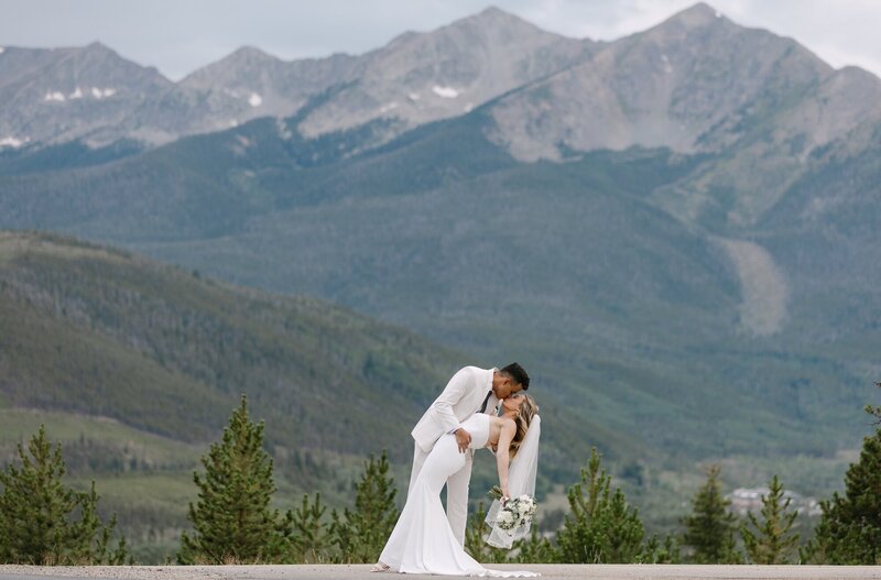 Epic mountain wedding photo in Breckenridge, Colorado of bride and groom kissing