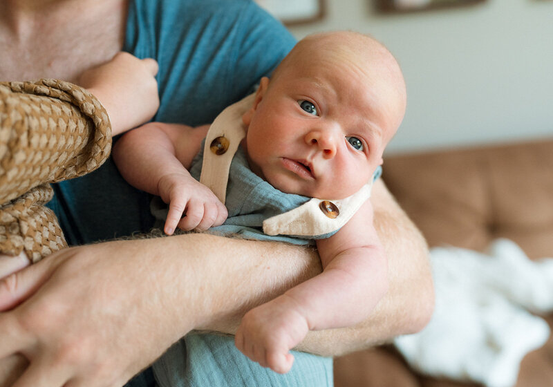 newborn baby boy looking at camera