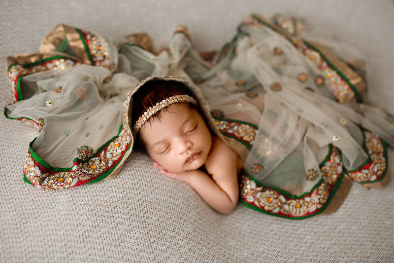 baby girl indian descent with moms wedding veil