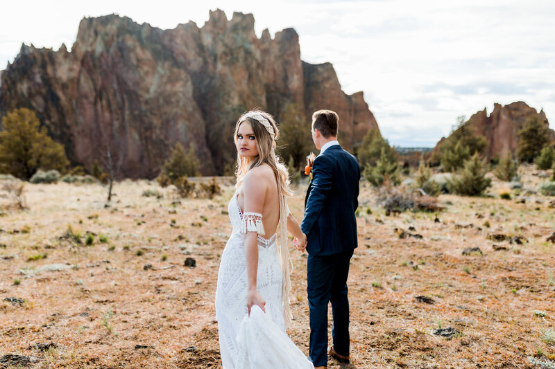 Couple exchanging vows in a breathtaking desert landscape, documented by an Oregon Coast Elopement and Wedding Photographer.