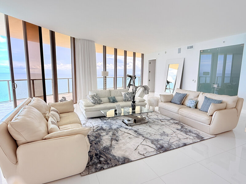 Expansive luxury living room with 10ft glass walls and direct ocean views at St. Regis PH-888