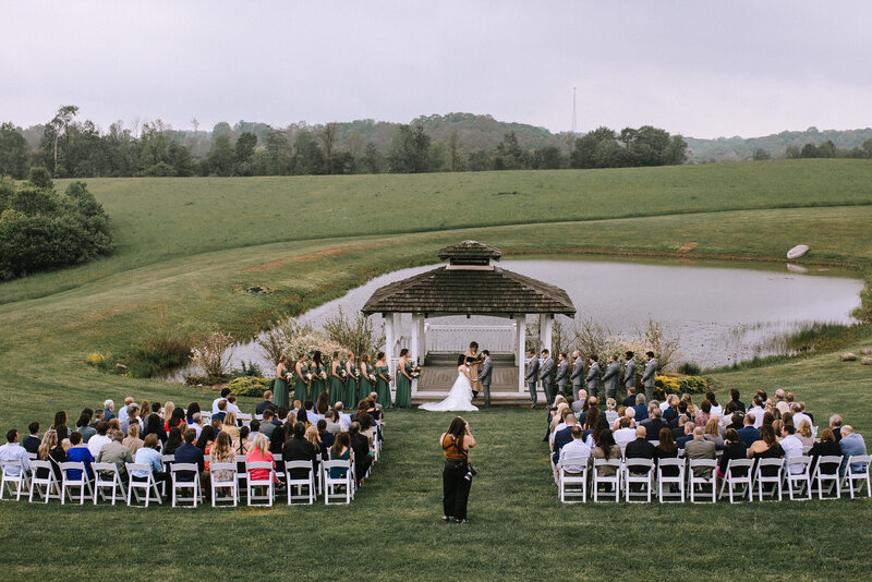 Kaitlin Powell Photography photographing a wedding ceremony at White Barn. 