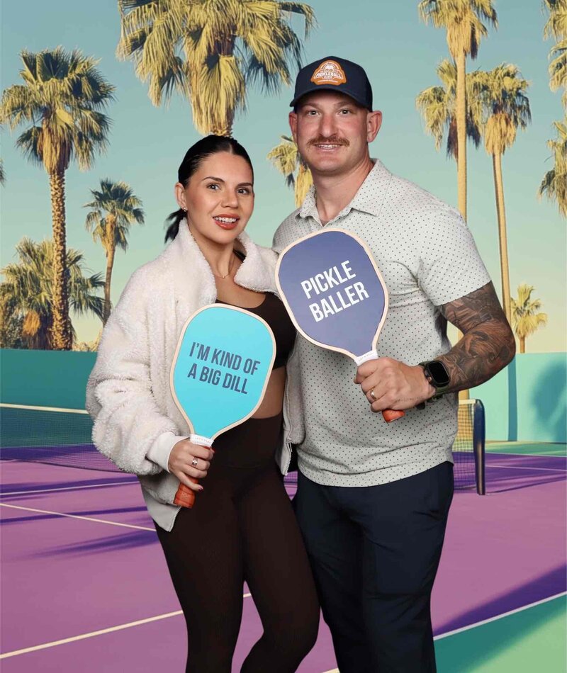 Two guests posing with pickleball paddles in front of a vibrant tennis court background using MISGIF’s magic green screen photo booth at a corporate event in Phoenix, Arizona