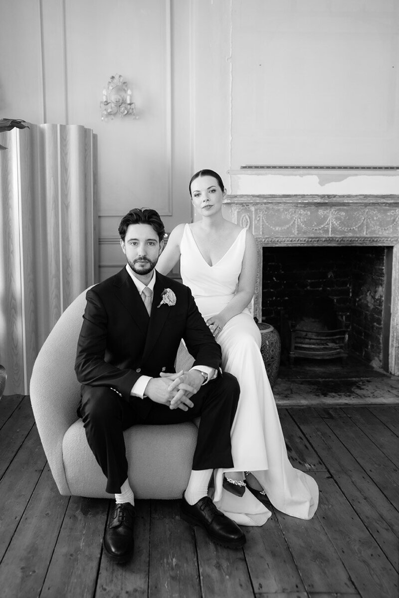 bride and groom sit for their modern editorial wedding photos