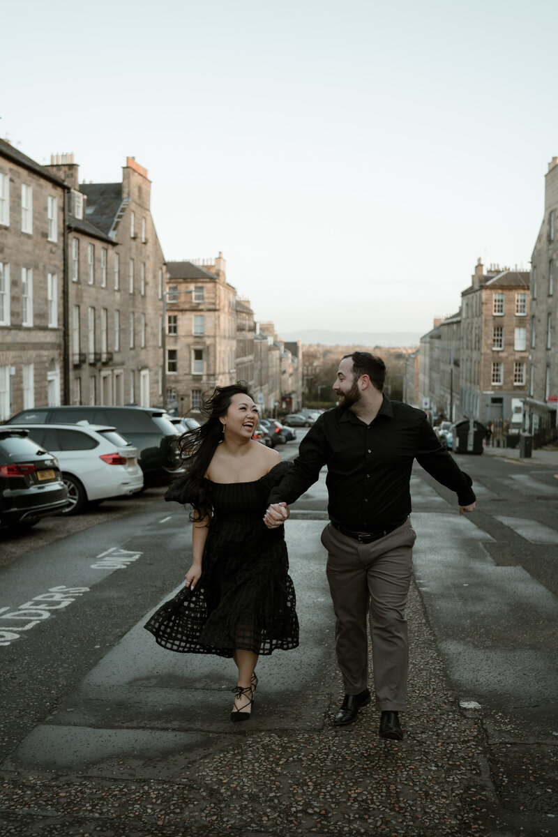 couple holding hands in scotland
