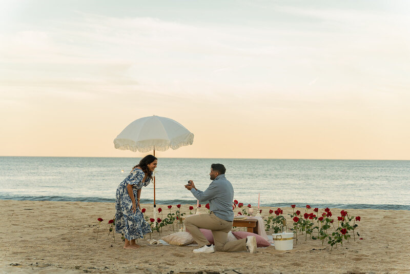 a beach proposal set up with couples doing proposals Styled proposal moment by Yours Truly, a wedding planner and designer in New Jersey.