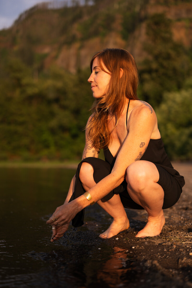 yoga teacher being playful in the river