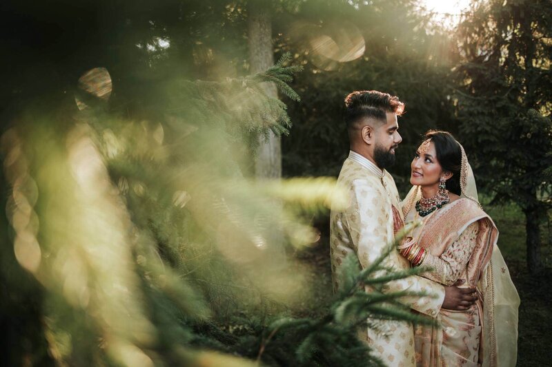 South Asian couple hug and enjoy solitude after ceremony in the canopy of the trees at Royal Alberts Palace