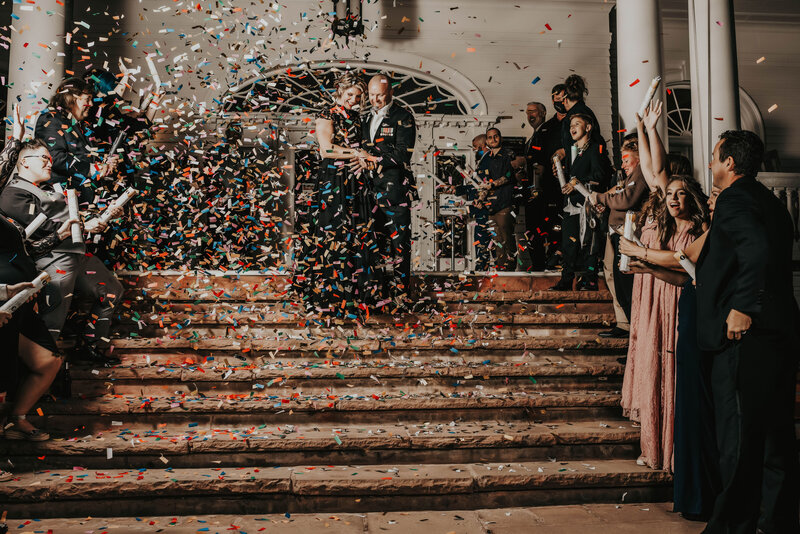 newlyweds walk down stairs with confetti