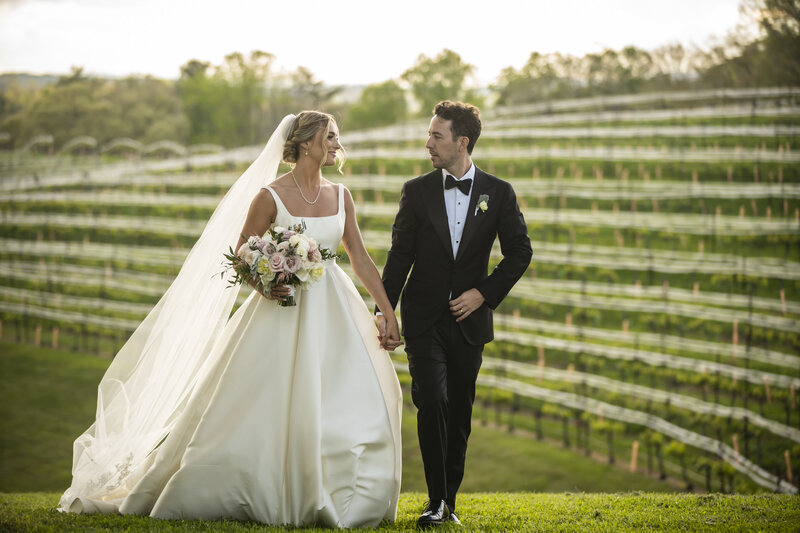 Bride and groom walking at Monteluce Winery.