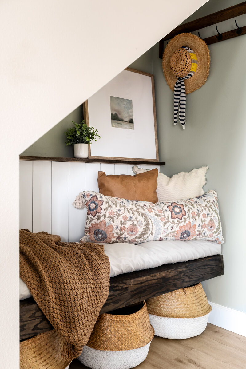 Under stair storage nook with bench, cushions and shelving