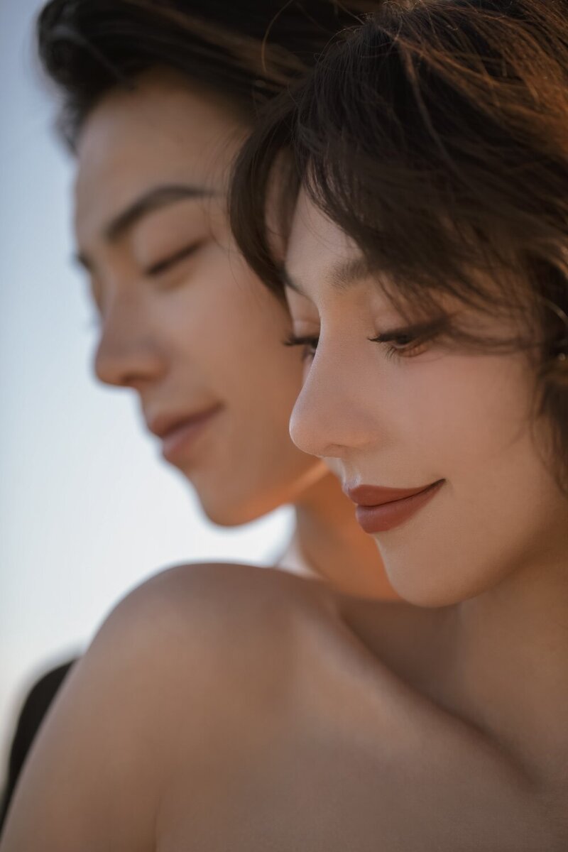 A close up image of a bride and groom together smiling.