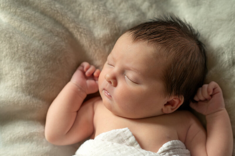 newborn baby girl sleeping on a fuzzy blanket by york pa photographer 