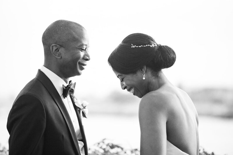 Emotional black-and-white portrait of a bride and groom sharing a quiet, joyful moment during their wedding ceremony — captured by Asia Pimentel Photography.