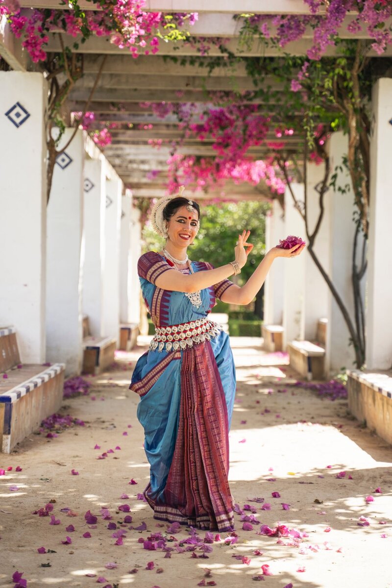Odissi dancer with flowers in a garden