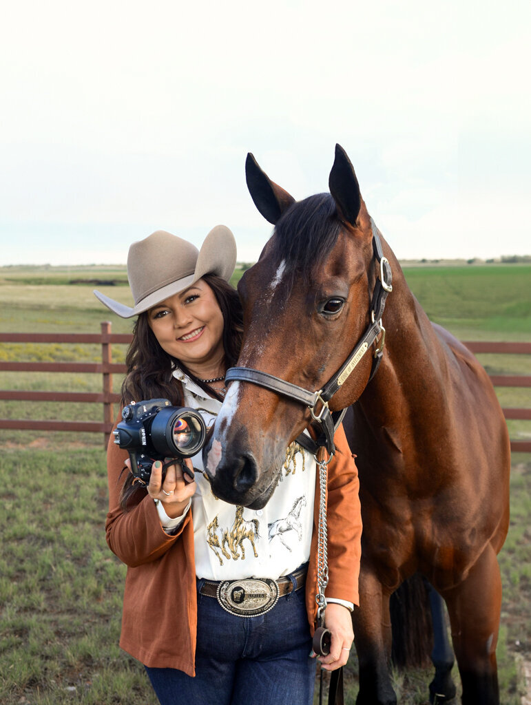 Hiliary Holbrook photographed on black background with horse Cody