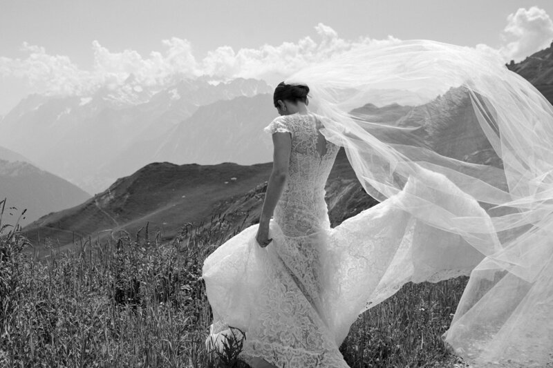 bride walking with wind blowing her veil