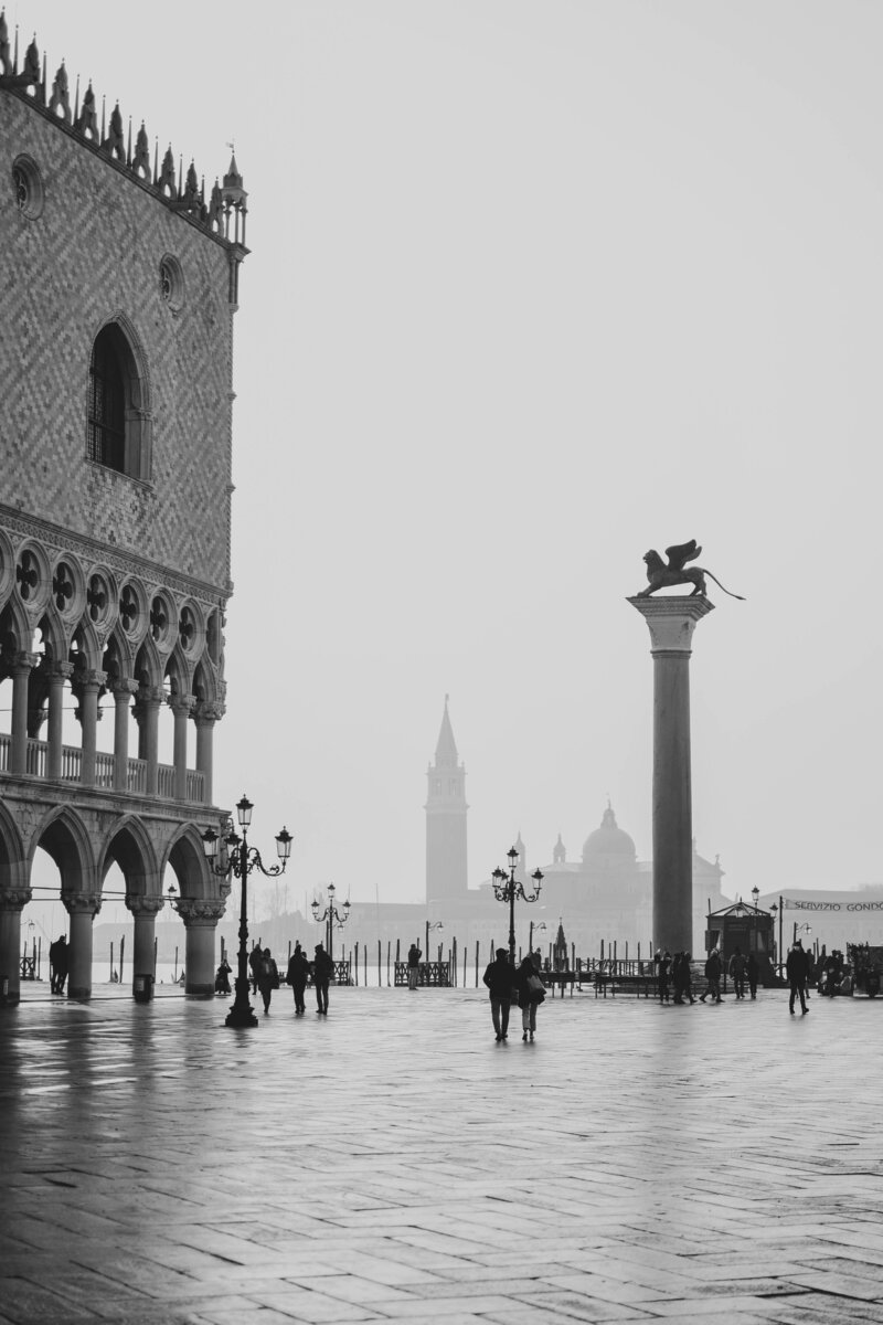 Piazzetta San Marco with the Doge's Palace, the Winged Lion of St. Mark column overlooking San Giorgio Maggiore tower on a foggy morning in Venice. 