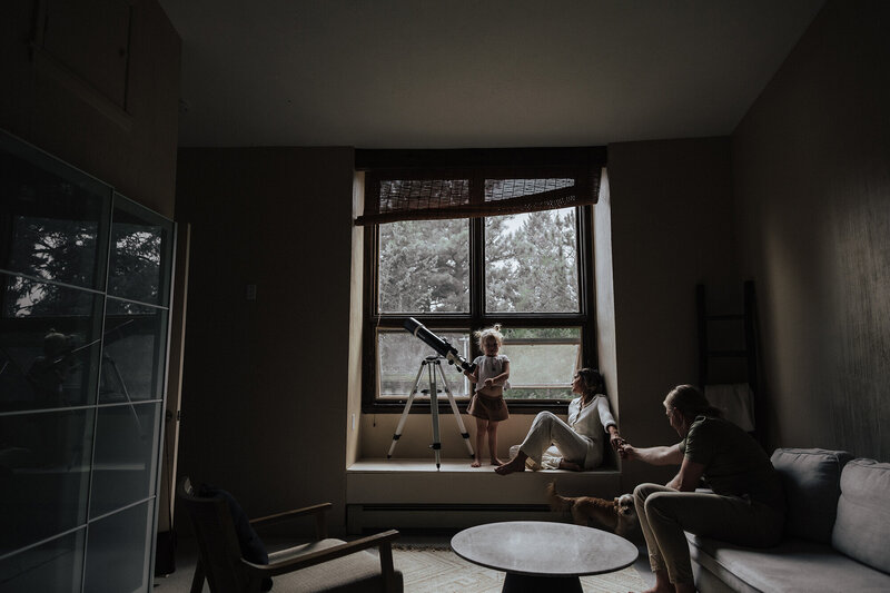 couple-with-daughter-moody-portrait-near-window