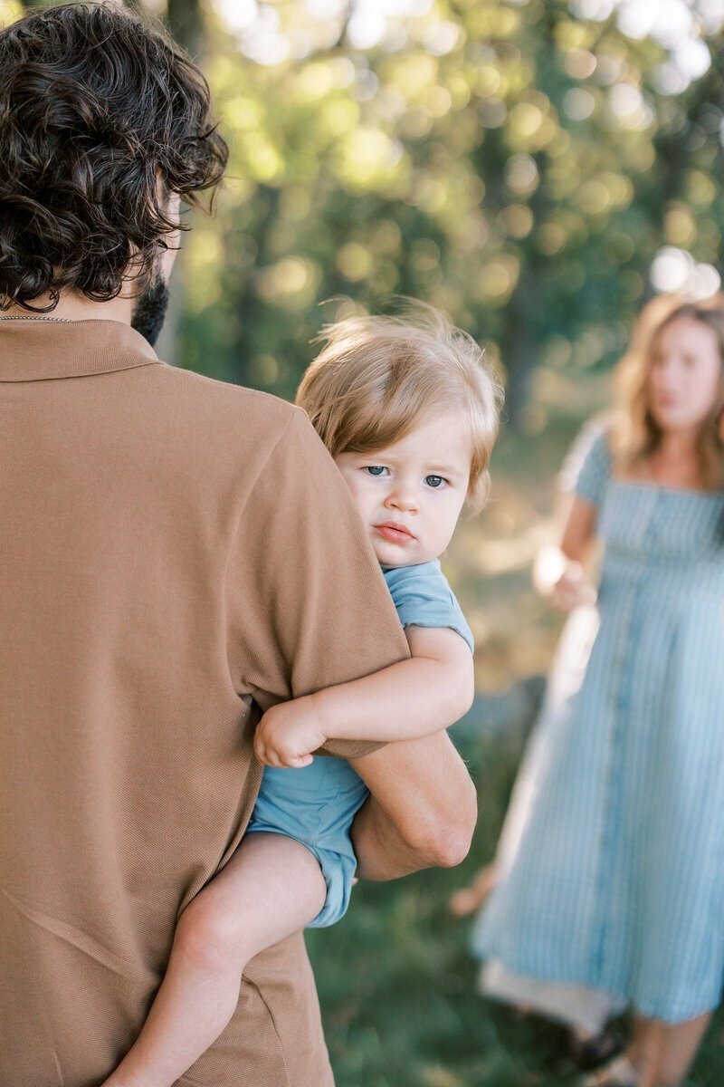 A beautiful family portrait of a dad, mom, and their baby, captured by Emily Barbara, family photographer in Milwaukee.