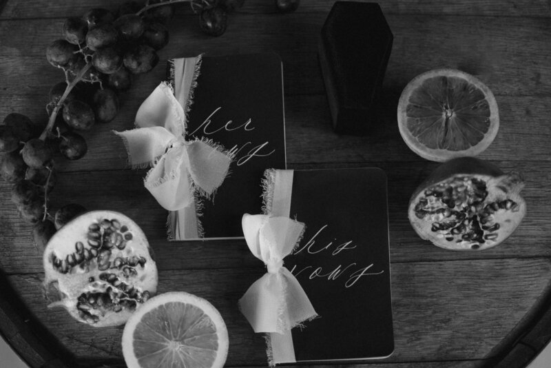 Vow books, coffin ring box and fruit being used as detail photos.
