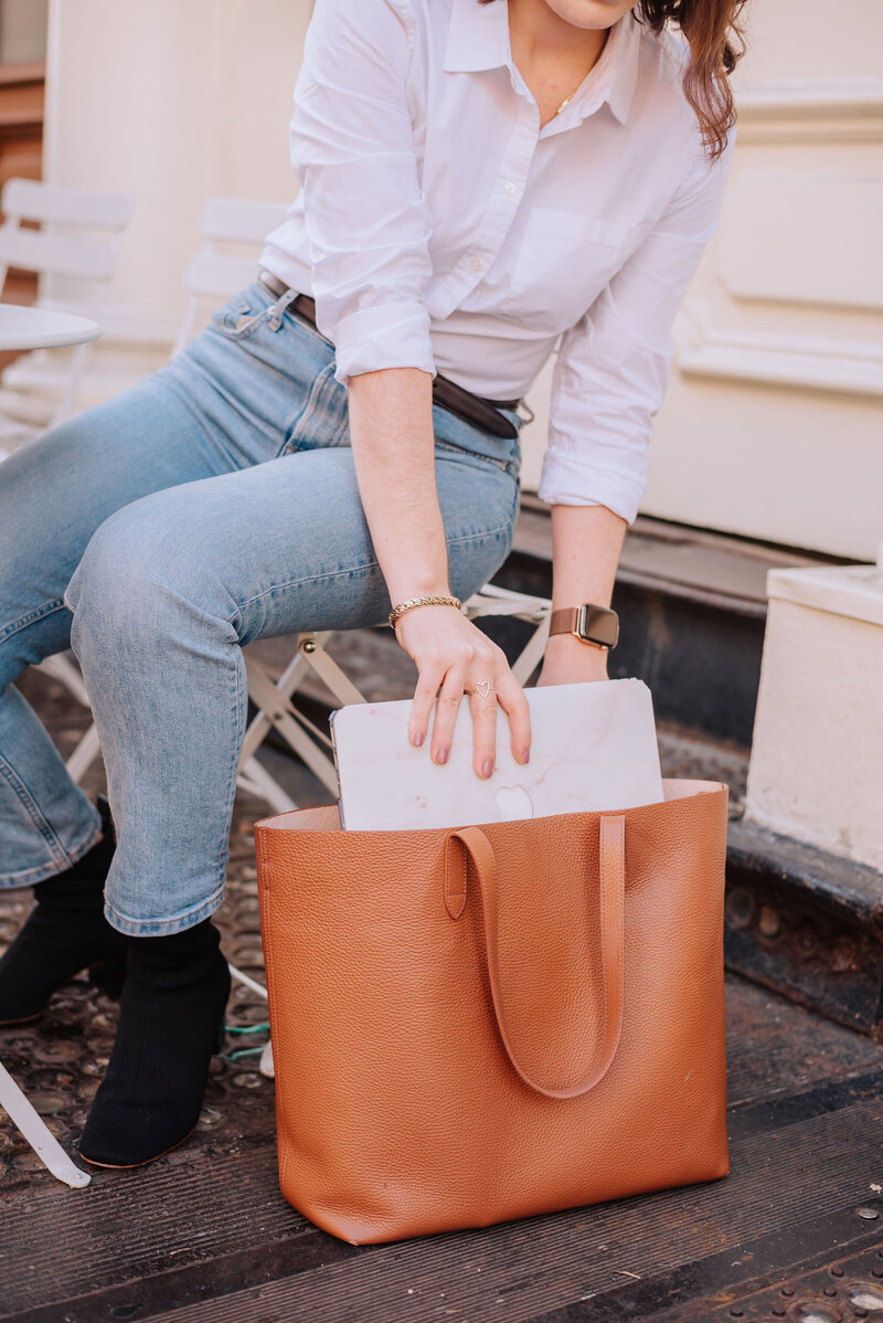 Madison pulling laptop out of tote bag