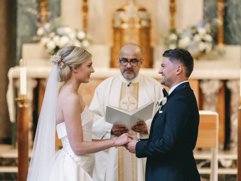 modern bride saying her vows while wearing her Grandma's vintage heirloom wax flower bridal crown restyled into a modern bridal hair comb