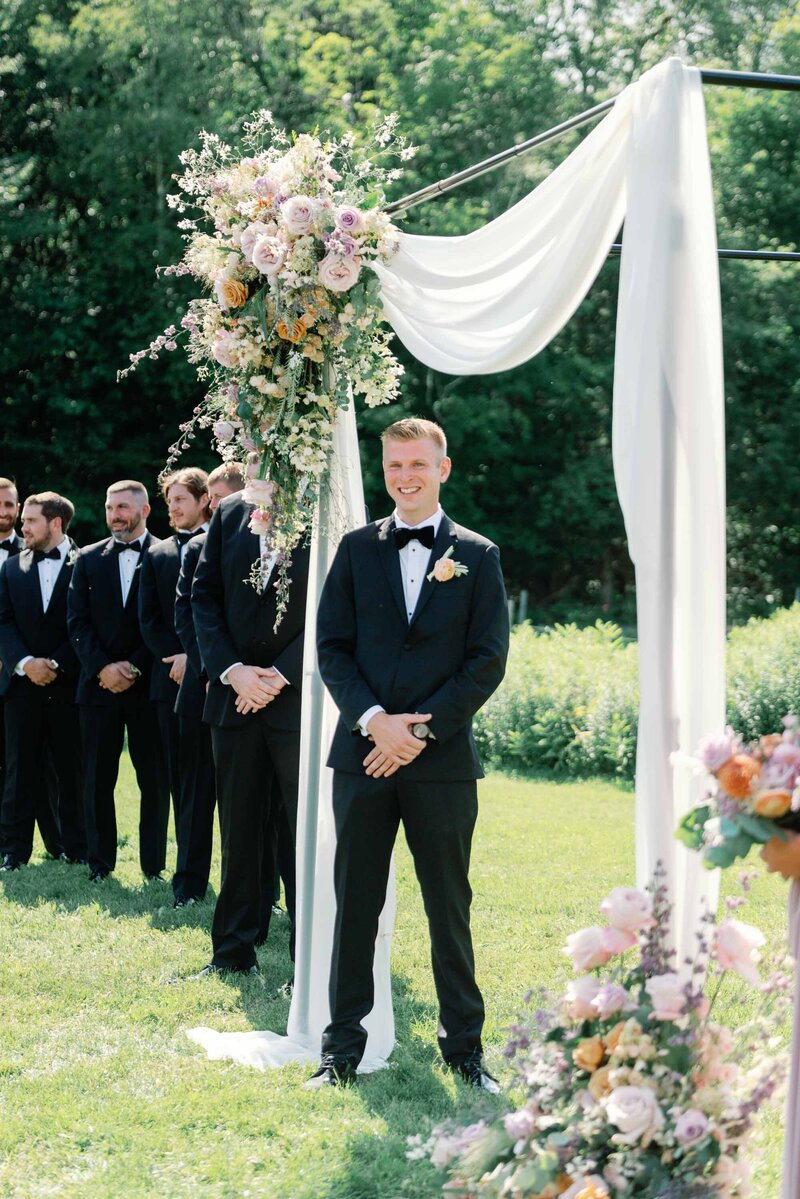 groom watches bride walk down the aisle at topnotch resort and spa vt wedding