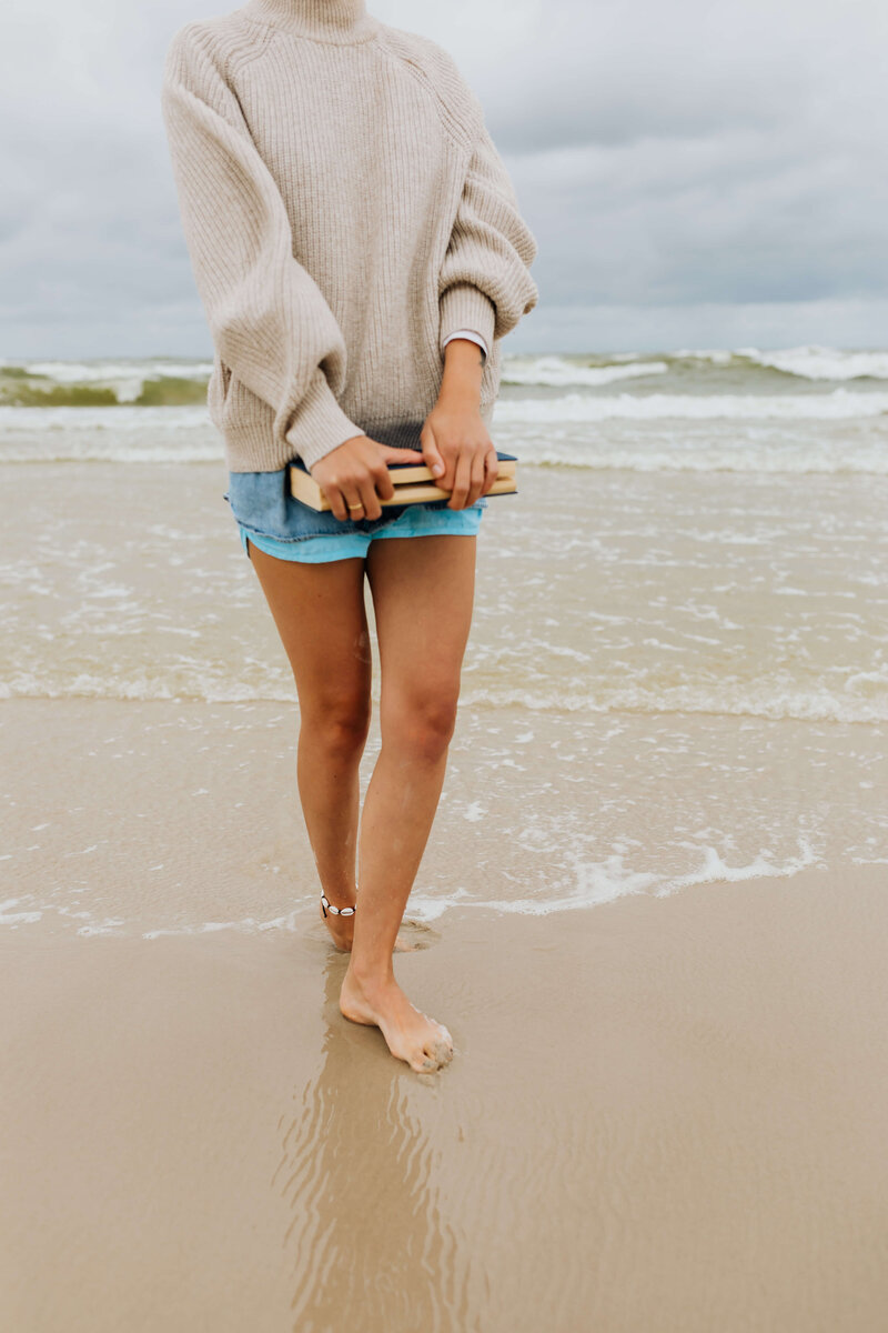 a-young-woman-with-a-book-on-the-seashore