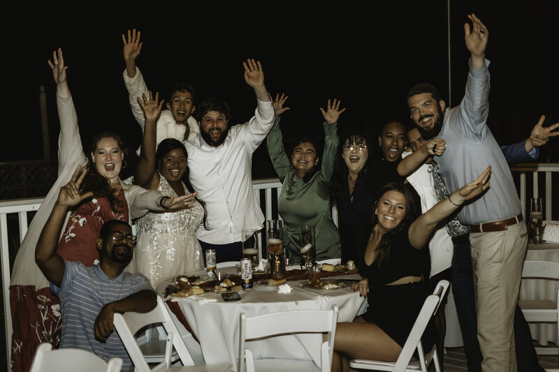 Group cheering during backyard wedding reception