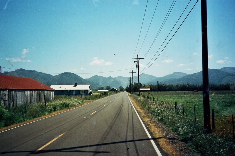 country road with mountains in background