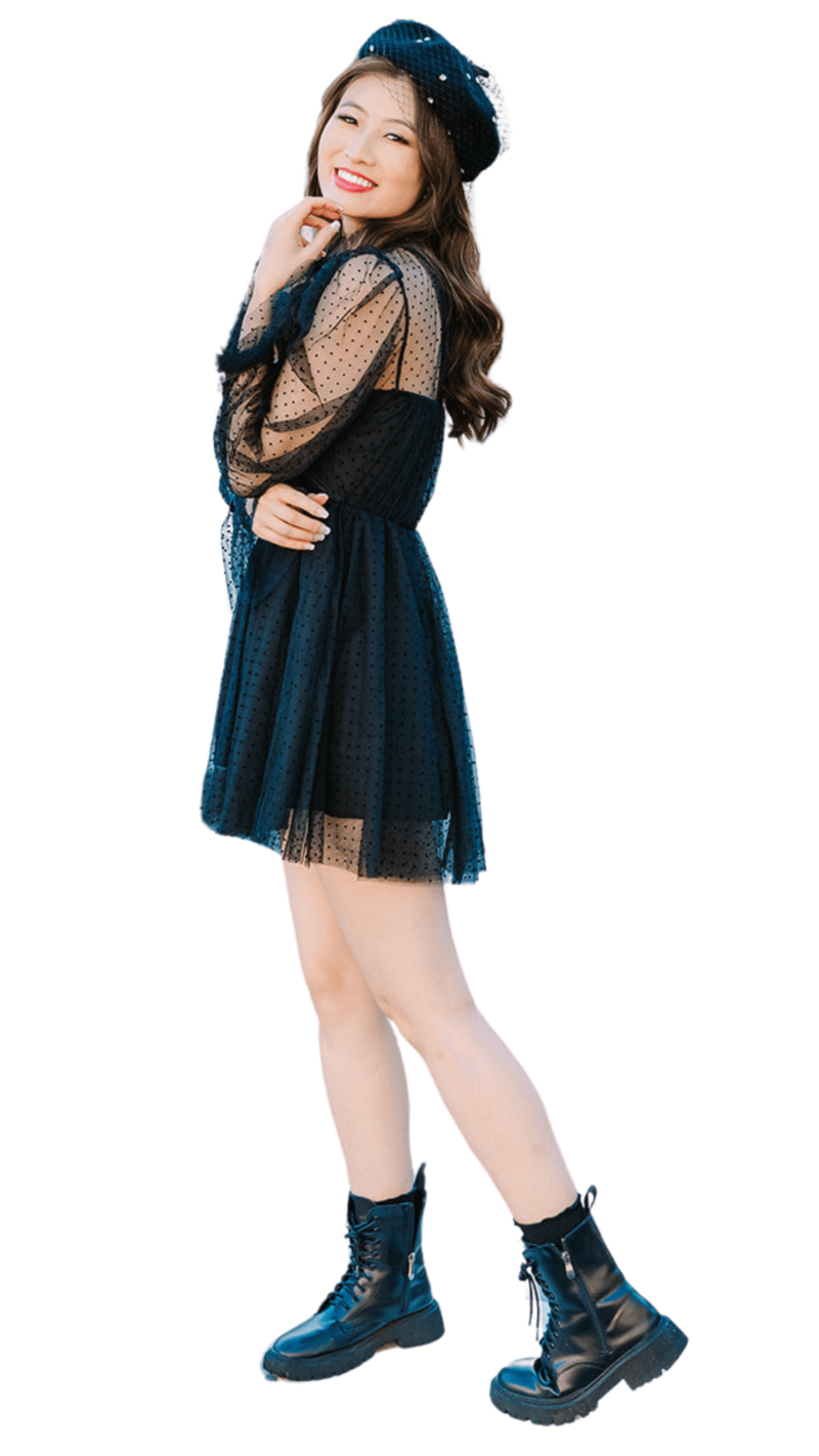 Stylish solo woman wearing a French beret, dress, and Doc Martens during a Paris photoshoot near the Eiffel Tower, Louvre, and Palais Royal.