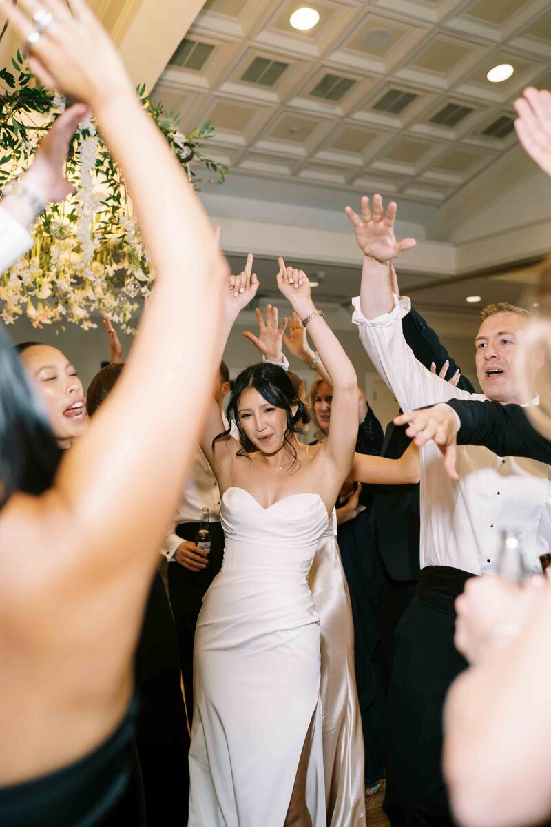 bride dancing happily at her wedding reception on the dancefloor