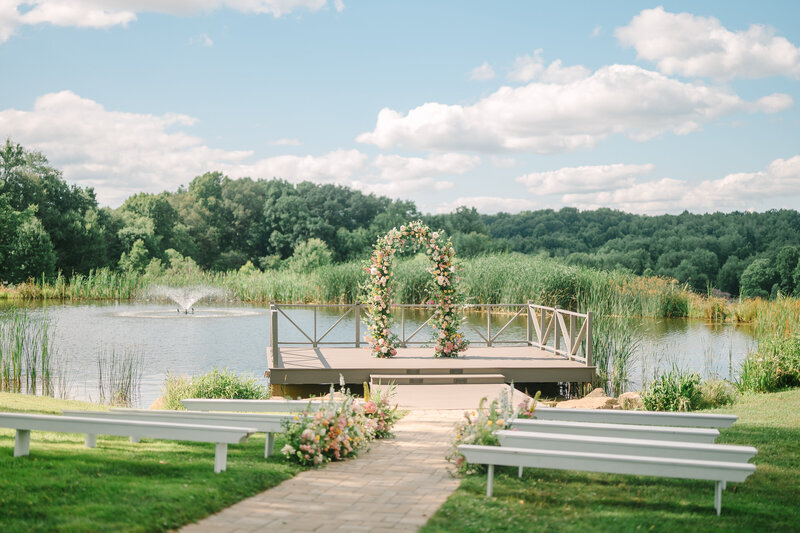 outdoor view of a pond wedding ceremony at Willowbrook Weddings, an upscale wedding venue with gardens