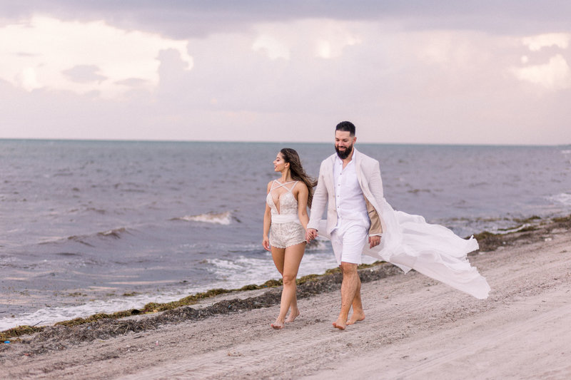 couple walking on the beach after their wedding