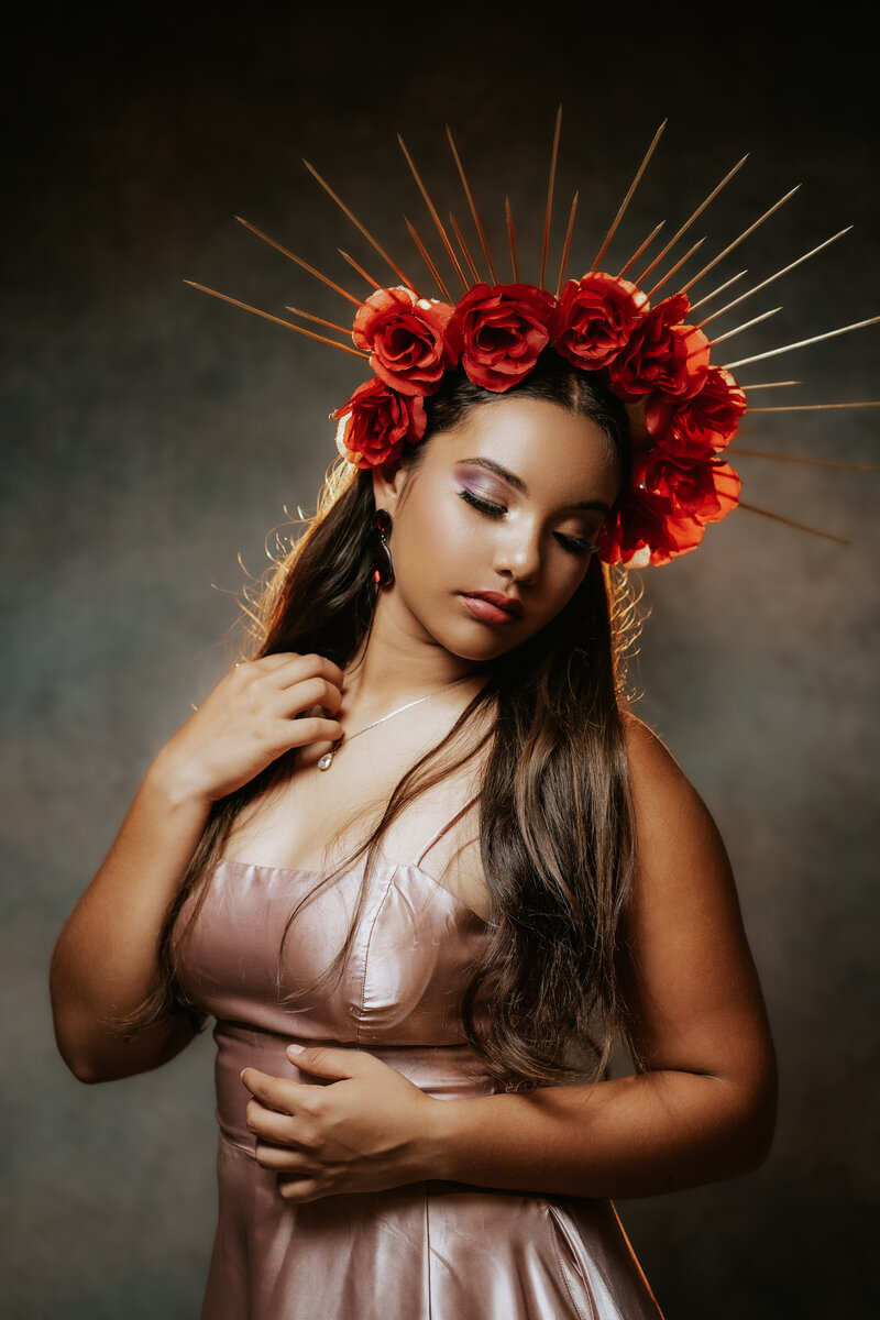 High-end studio portrait of a girl in a DIY golden spike crown with roses