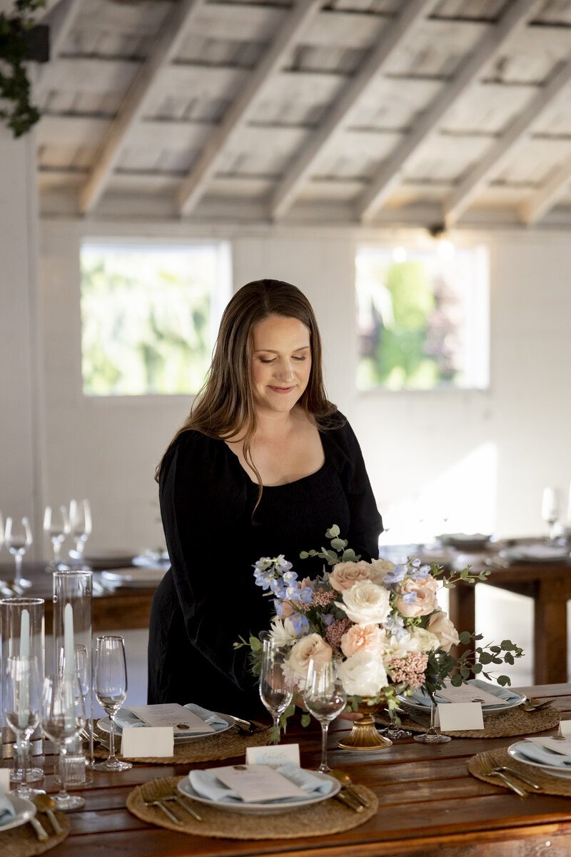Jessica Young setting up table centerpiece