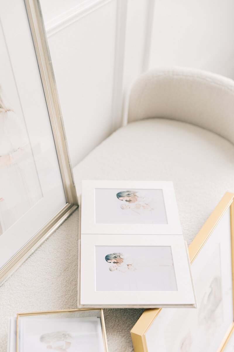 An elegantly displayed folio album and frames, showcasing cherished memories captured by a photographer in Charlotte, NC