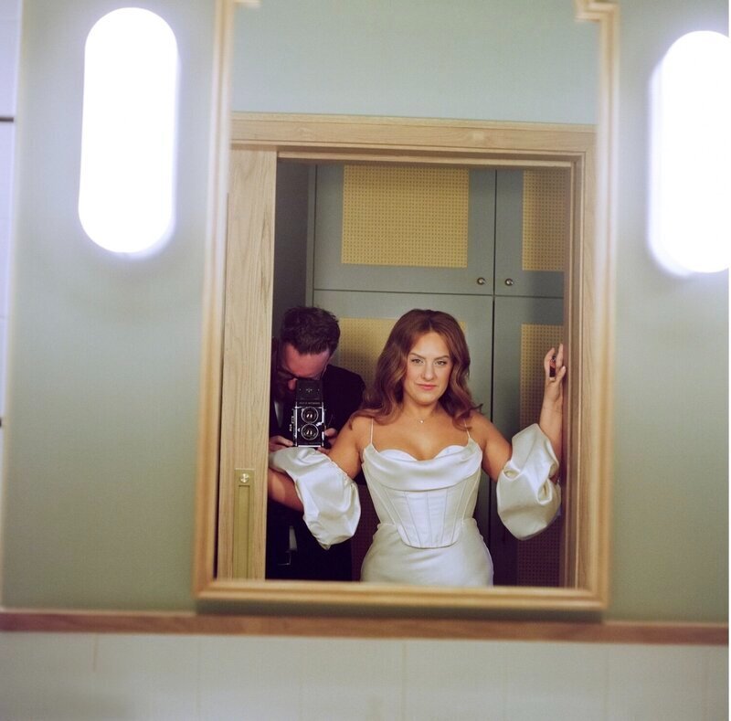 bride and photographer in mirror by documentary wedding photographer Christian Noble