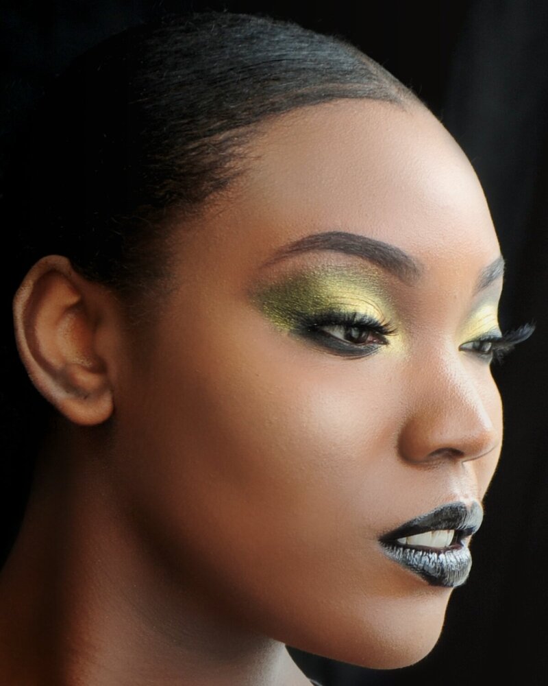Editorial-inspired makeup with metallic gold eyeshadow and dramatic black lipstick—ideal for photoshoots or bold event glam.