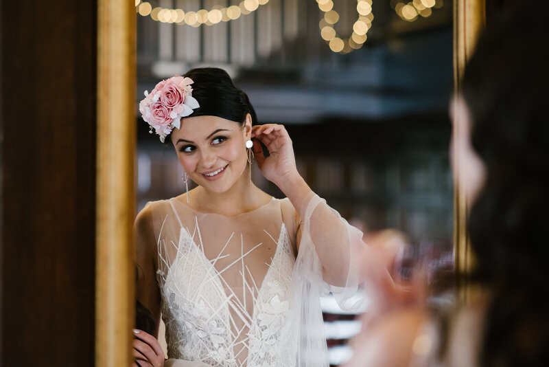 Bride in vintage style wedding dress and floral headband head piece.