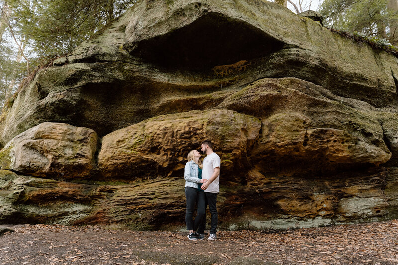 Couple standing under a rocky ledge at Ledges in Cuyahoga Valley National Park.