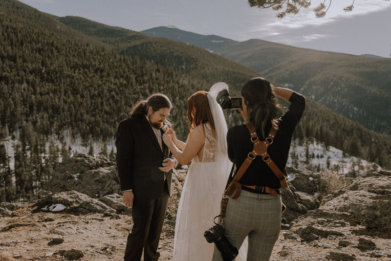 spenser chambers photographer in action taking photos of couple on mountain