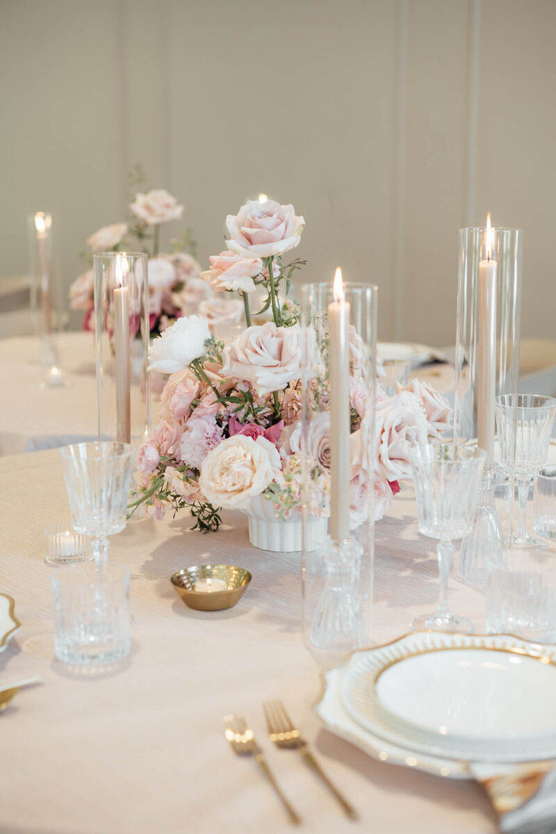 Romantic blush pink floral centerpiece with candles