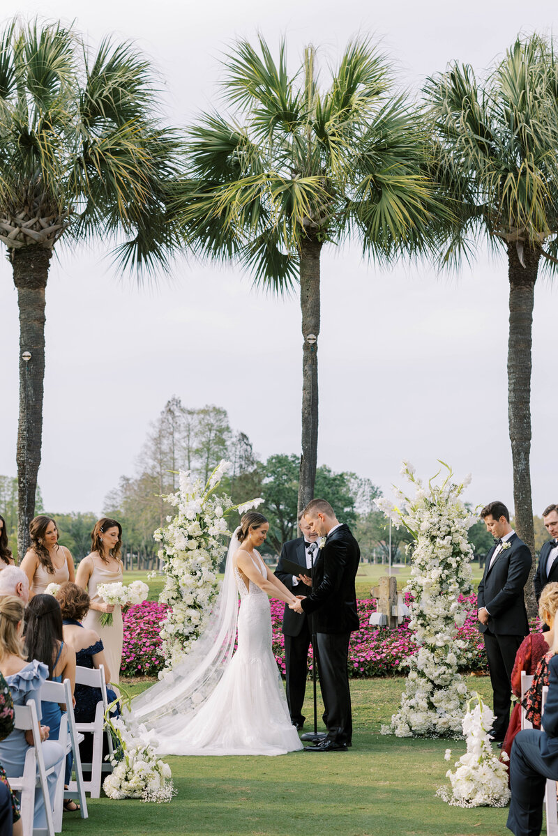 Bride and groom saying their wedding vows at luxury outdoor wedding