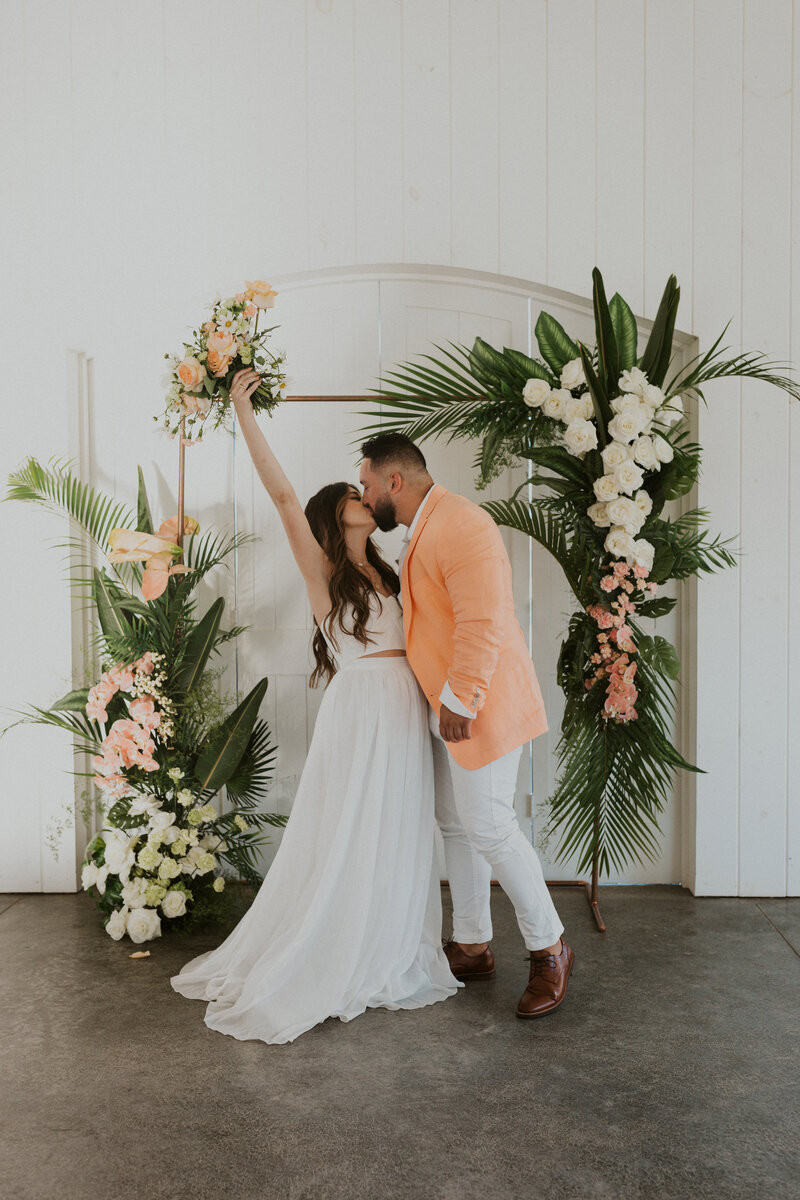 Bride and groom share their first kiss after their wedding ceremony