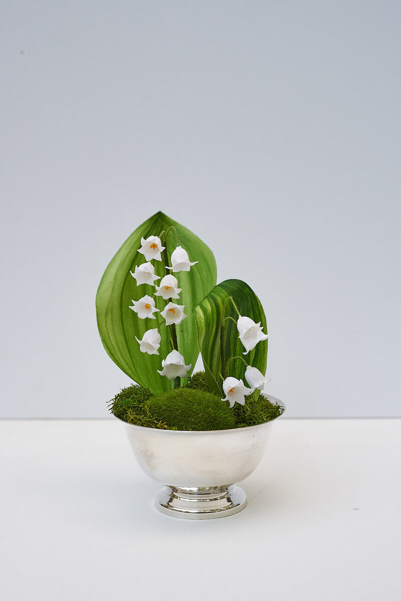 An everlasting petite lily of the valley arrangement in paper