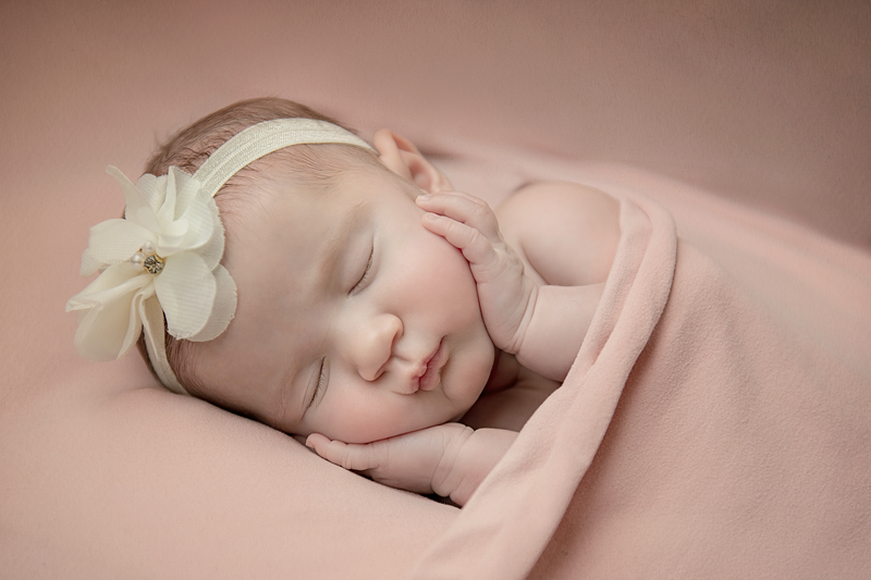 Baby girl in pink newborn portrait session