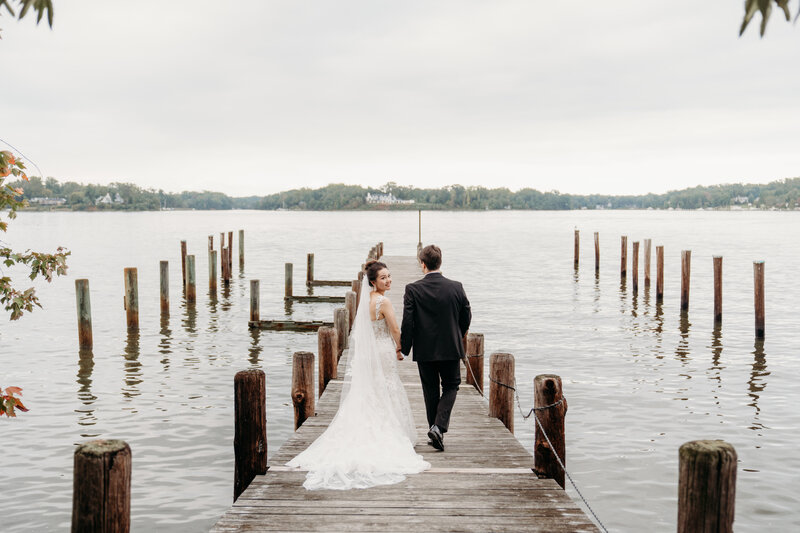Bride and Groom walking on boardwalk in Annapolis